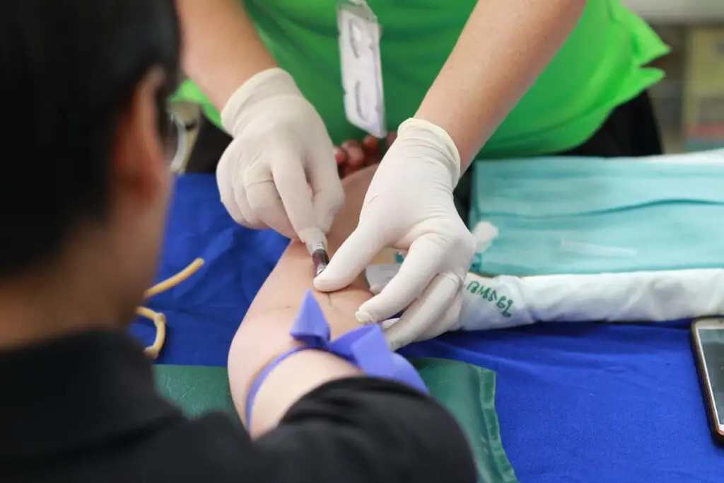 Clinician administering an injection into a patient’s arm